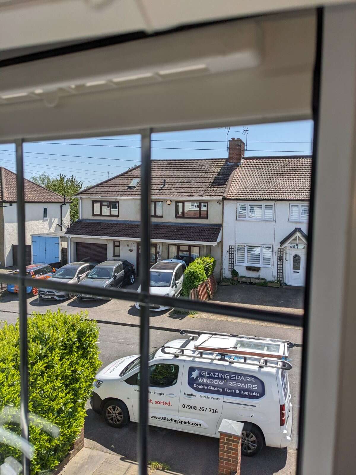 Glass Vent fitted from inside a bedroom, with the Glazing Spark van parked on the drive outside