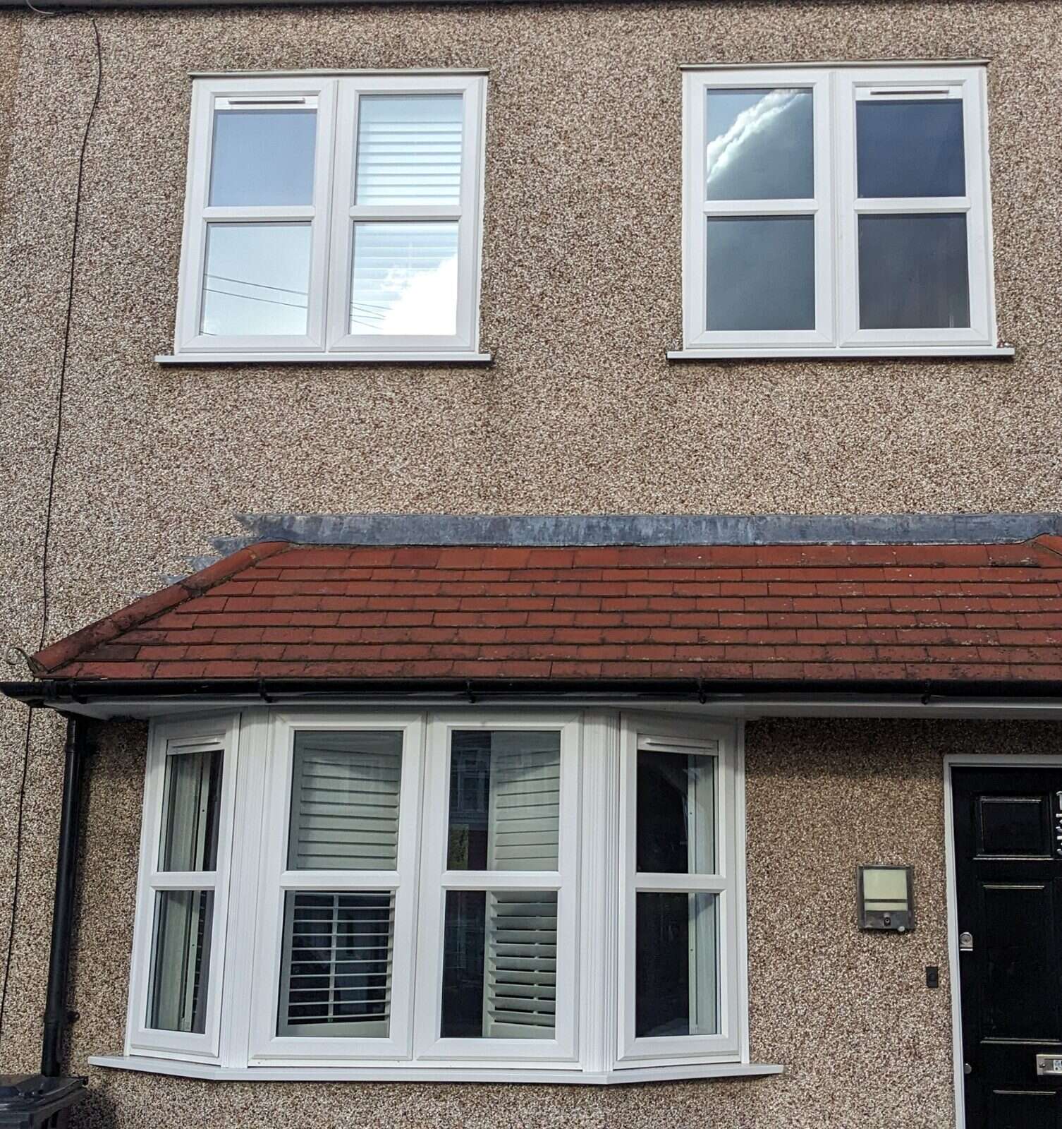 Brown pebbledash home with a bay window after Glass Vent installation