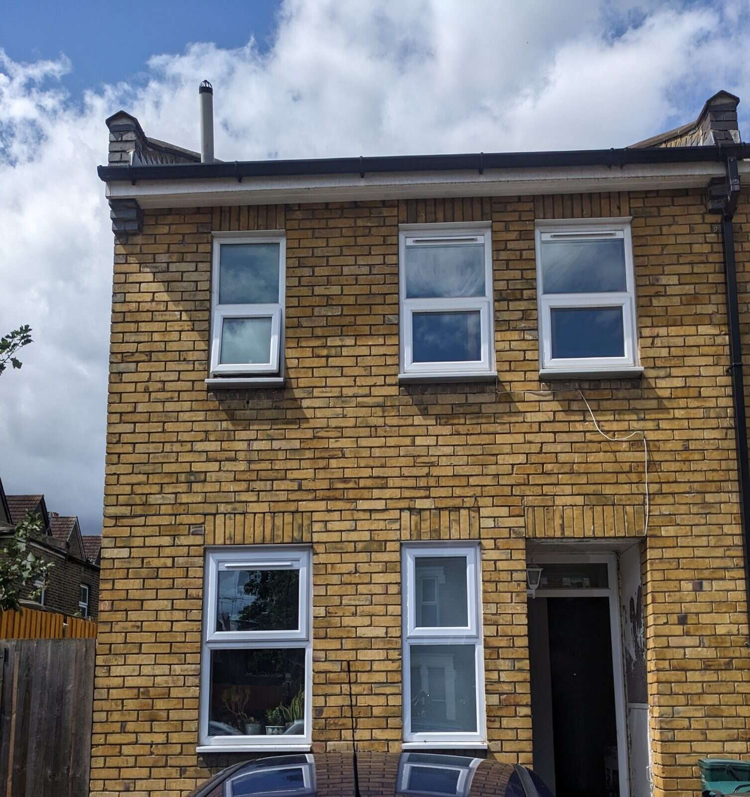 Stock-brick terraced home with four windows fitted with retrofit Glass Vents