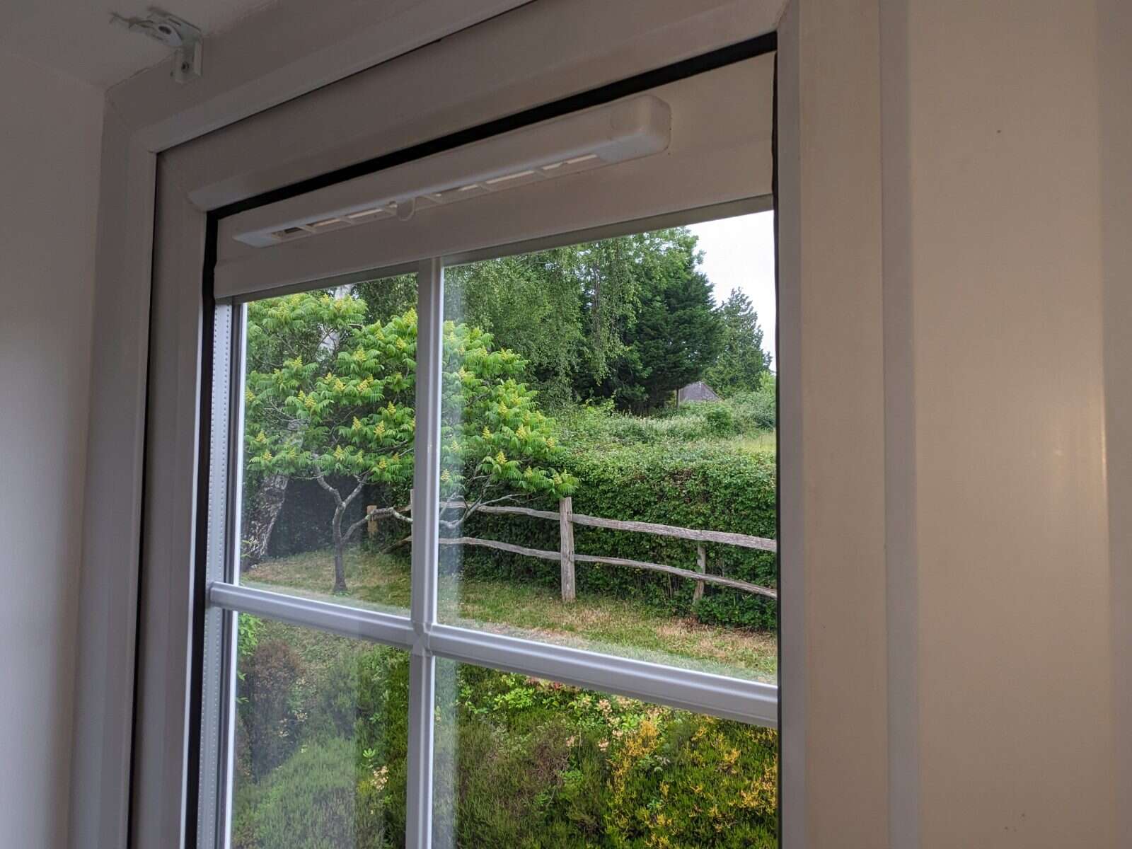 Slimline retrofit trickle vent fitted above a window pane, clearing the condensation that had built up on the glass